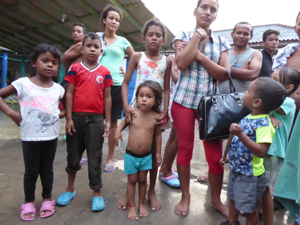 Families at an informal shelter in a car park in Riohacha where they pay to sleep on the floor.