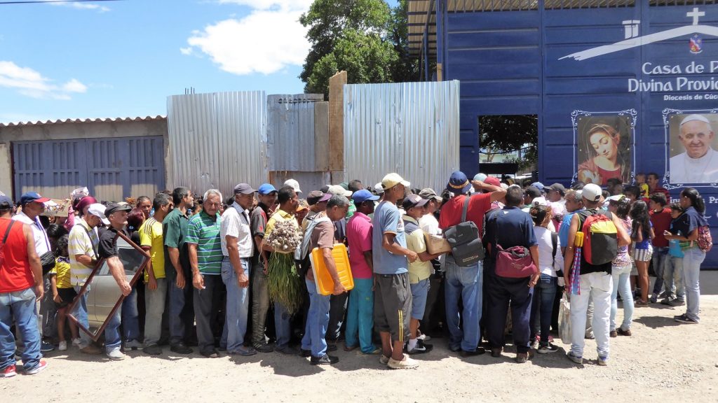 Migrants queuing for free food at a church-run comedor in Villa Rosario close to the border in Norte de Santander.