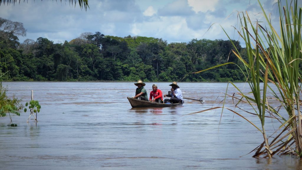 Colombian Amazon El Encanto: Canoe and peque-peque on the Rio Putumayo down-river from Pto Alegria.  This is a conflict area in places, so people are surprised to see travellers. 