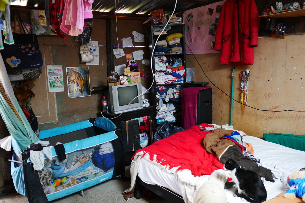 Basic living in Ciudad Bolivar. The harsh climate - cold wind and rain  - and muddy streets make housing precarious.
