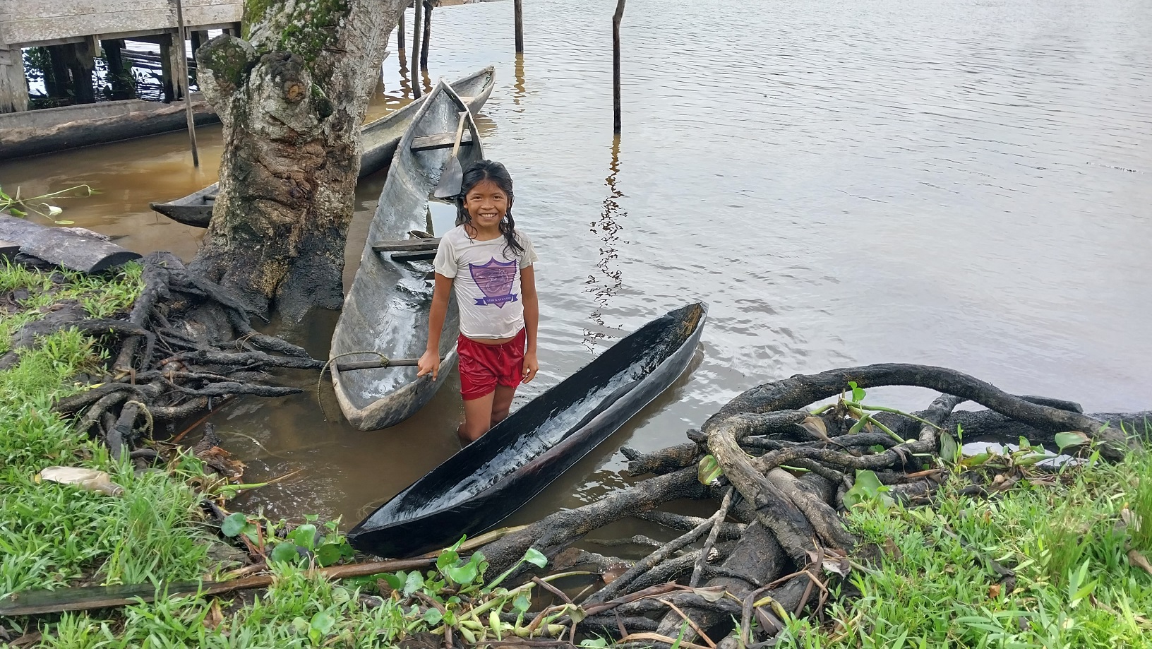 Warao girl with her pint-sized curiara canoe. 