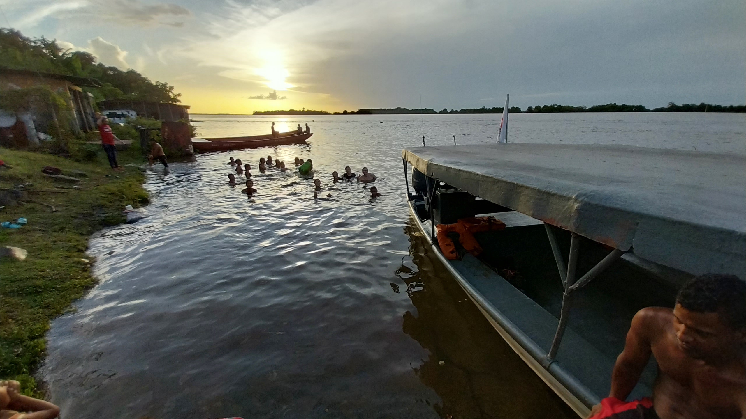 Sunset at the riverbank, the community gathers to cool off in the Orinoco.